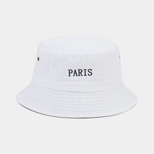 Detailed embroidery of PARIS on a white cotton bucket hat with breathable metal eyelets