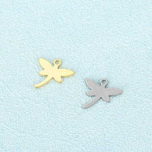 Golden and silver stainless steel dragonfly charms for DIY necklaces on a blue background