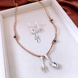 Unique silver spoon and fork jewelry set with woven cord necklace and matching earrings