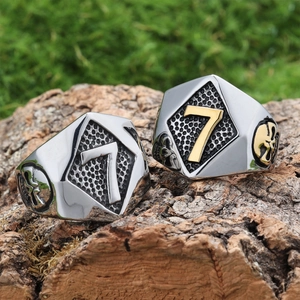 Men's punk skull ring with lucky number 7 in silver and gold on a rustic wood background