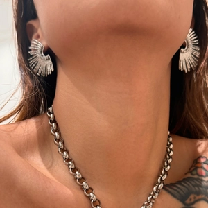 Silver vintage sunburst earrings and chain necklace set worn by a female model