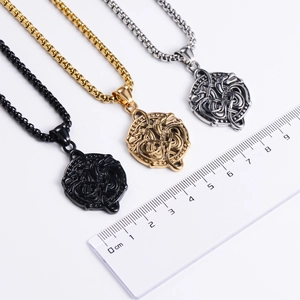 Measurement of Chinese style dragon pendant in gold silver and black with ruler