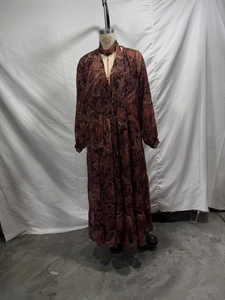 Detail view of burgundy paisley print maxi dress with deep v-neck on a mannequin