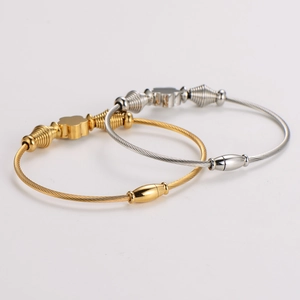 Intertwined gold and silver wire cable bracelets with crystal flower charms
