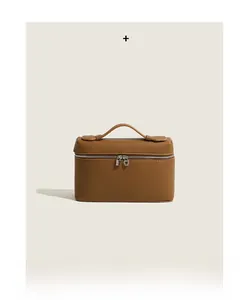 Detail of premium brown pebble leather handbag featuring silver two-way metal zippers