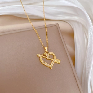 Elegant gold titanium steel heart necklace with cubic zirconia on beige silk