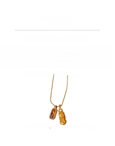 Detailed view of the gold PiXiu pendant and vajra set encrusted with white zircon stones