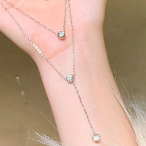Elegant silver layered necklace set with sparkling zircon pendants on hands
