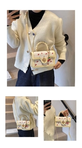 Detail view of cream handbag with cherry print and woven handle shown in various carry styles