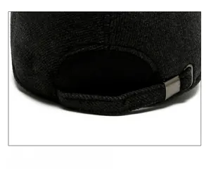 Detail of adjustable metal buckle and wool blend strap on dark grey baseball cap