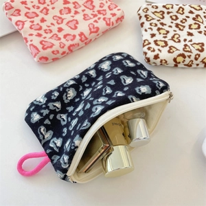Macro view of blue heart leopard print pouch showing cosmetics storage capacity