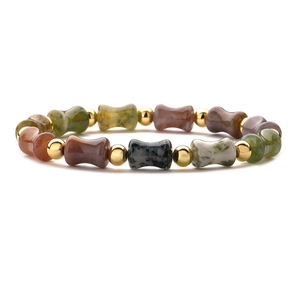 Bamboo style beaded bracelet with natural stones and gold accents on a white background