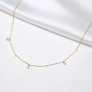 Detail view of gold titanium necklace featuring alternating square sequins and zircon crystals