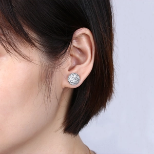 Close-up of S925 silver round stud earrings with sparkling crystal clusters on ear