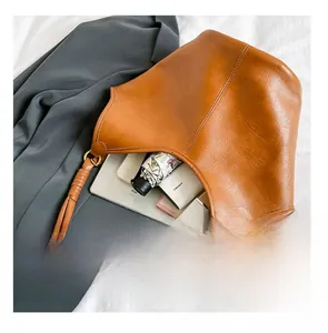 Spacious interior of caramel tote bag showing storage for iPad, umbrella and cosmetics