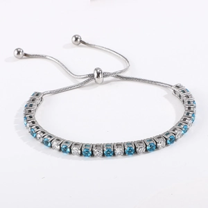 Detail of adjustable silver tennis bracelet with alternating blue and white zircon stones