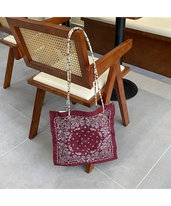 Close-up of deep red paisley tote bag with unique colorful beaded shoulder strap