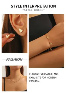 Detail view of a gold-tone heart jewelry set featuring white enamel earrings and necklaces