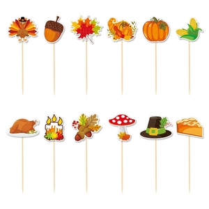 Close-up of assorted Thanksgiving cupcake toppers with turkey and maple leaf designs