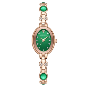 Elegant rose gold emerald green oval watch with diamond scales and clover bracelet band
