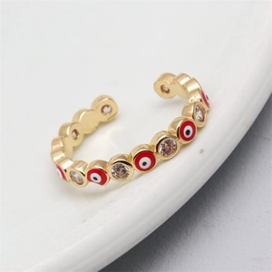 Detail of gold evil eye ring with red enamel and micro-set cubic zirconia crystals