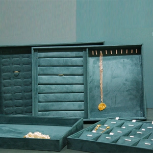Dark green velvet jewelry display trays for rings, necklaces and luxury accessories