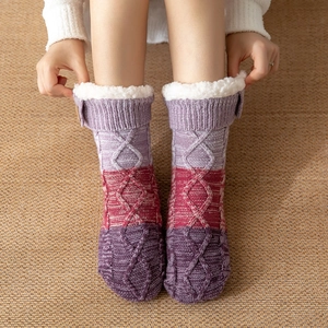 Close-up of thick gradient knit winter socks with cozy white faux fur lining inside