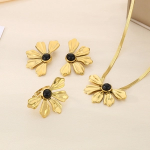 Golden 18K petal jewelry set featuring a necklace, ring and earrings with black gemstones