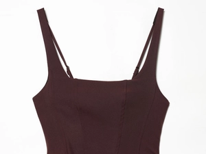 Detailed view of the square neckline and knit texture on the dark brown backless dress