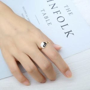 Close-up of a gold stainless steel ring with a black and white Tai Chi Yin Yang symbol