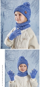 Detail of children's blue knit set featuring soft pom-pom hat and matching scarf