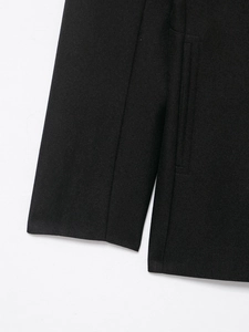 Detailed close-up showing high-density black wool blend fabric texture and diagonal weave