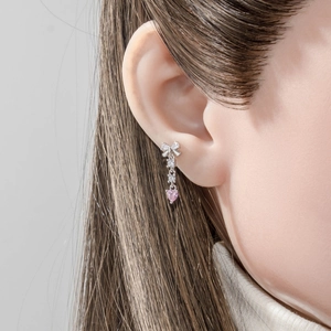 Elegant silver bow stud earring with a pink heart tassel and sparkling crystals