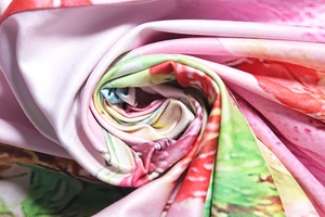 Macro shot of colorful floral print fabric with soft texture and twill knit pattern