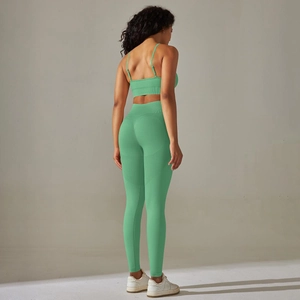 Close-up of mint green seamless knitted yoga set with high waist and backless bra