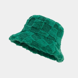 Close-up of green checkerboard plush bucket hat showing fuzzy texture and retro pattern