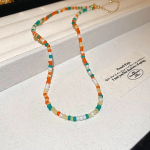Detailed shot of rainbow frosted bead necklace with adjustable golden lobster clasp and chain