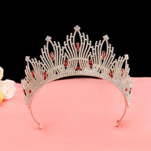 Detailed view of silver alloy bridal crown featuring red gemstones and sparkling rhinestones