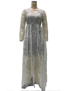 Detail view of intricate white floral lace texture and embroidery on long sleeve gown