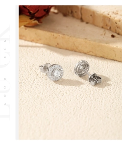 Detailed view of silver S925 halo stud earrings with brilliant round moissanite stones