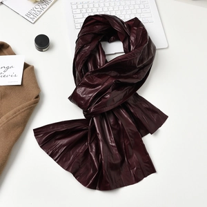 Chic burgundy leather scarf with pleated texture and stylish winter aesthetic