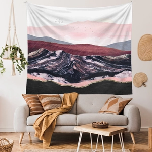 Abstract mountain tapestry with marble texture and birds hanging over a modern sofa
