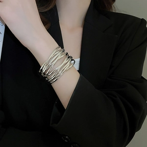 Macro view of multi-layer silver metal bracelet with a sleek polished finish on wrist