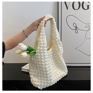 Detail of white bubble texture fabric on a large capacity popcorn shoulder tote bag
