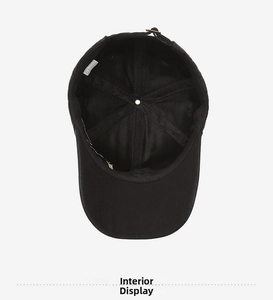 Detailed interior view of a black washed denim baseball cap with inner stitching and labels