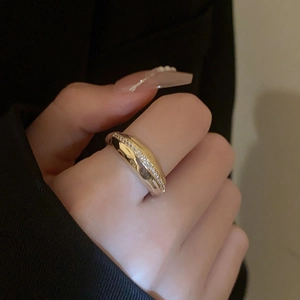 Detail of gold plated ring with double layers and shimmering zircons on a female finger