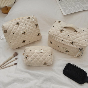 Detailed set of three cream quilted bear storage bags with high-quality embroidery
