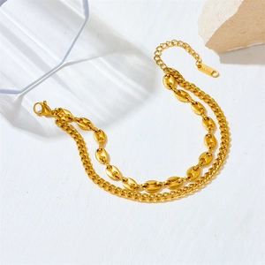Close-up of golden stainless steel double-layer chain with coffee bean and Cuban links