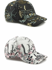 Detail of ethnic style baseball caps with intricate floral and bird embroidery patterns