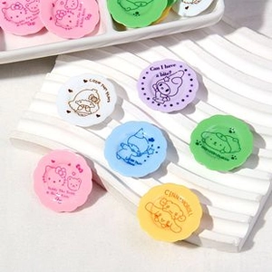Macro view of colorful miniature resin plates with cute cartoon patterns and English text